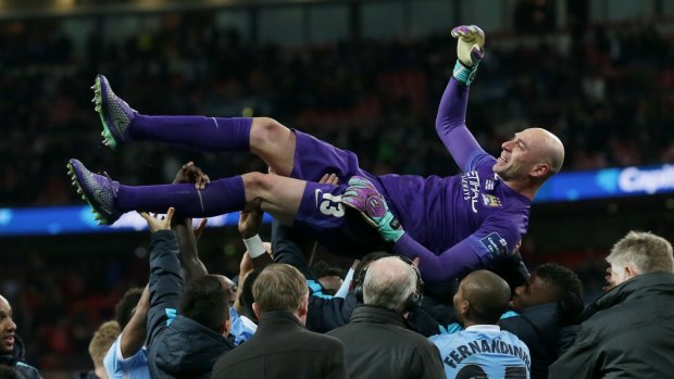 Manchester City players celebrate their goalkeeper Willy Caballero.