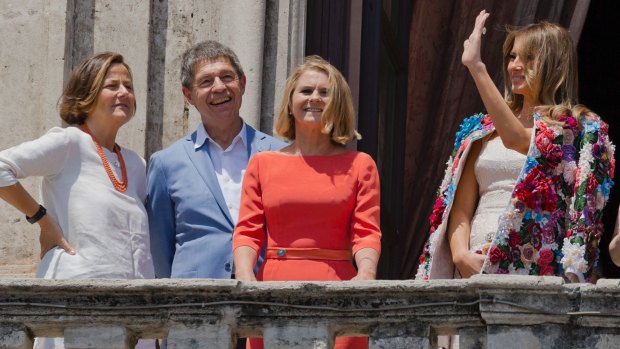 First spouses: Melania Trump (right) waves as she stands with, from left, the spouse of Italian Premier Paolo Gentiloni, Emanuela Mauro, spouse of German Chancellor Angela Merkel, Joachim Sauer, and spouse of European Council President Donald Tusk, Malgorzata Tusk.