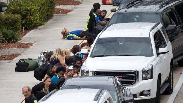 People take cover outside Fort Lauderdale-Hollywood International Airport.