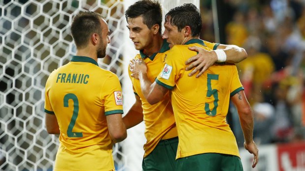 Wanted man: Tomi Juric (centre) celebrates his goal against Oman