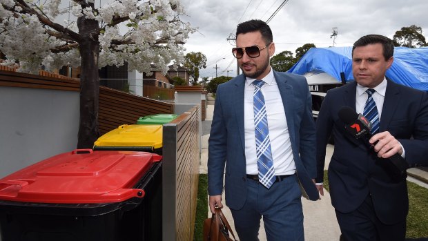 Salim Mehager questioned by a journalist outside his Lidcombe home on Tuesday.
