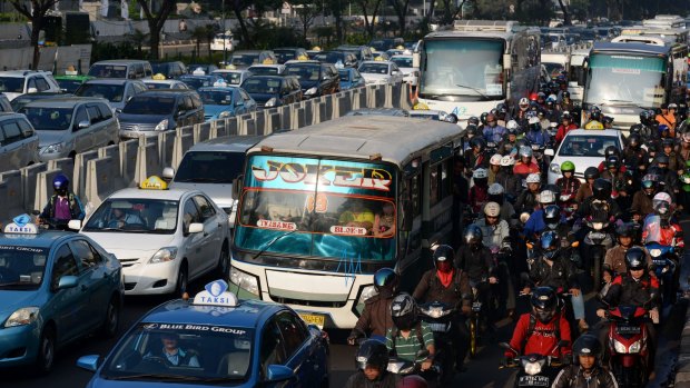 Cars, buses and motorbikes caught in Jakarta's commuter crawl.
