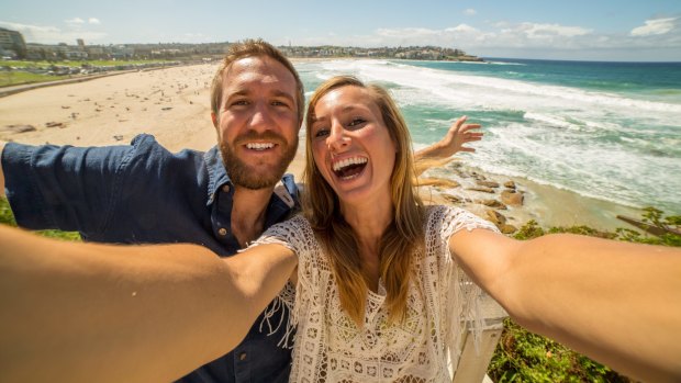 Happy tourists grab a selfie at Bondi Beach.