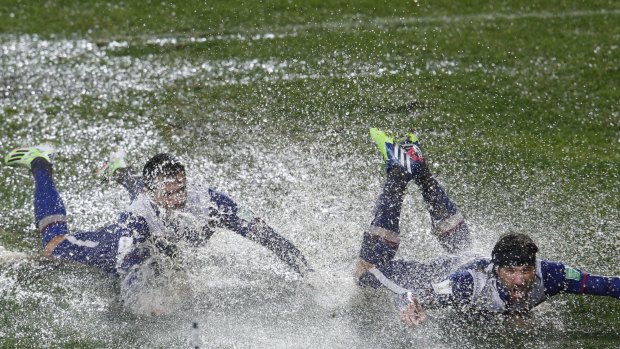 Watery grave: Cruz Azul players celebrate after downing the Wanderers on a sodden pitch in Rabat.