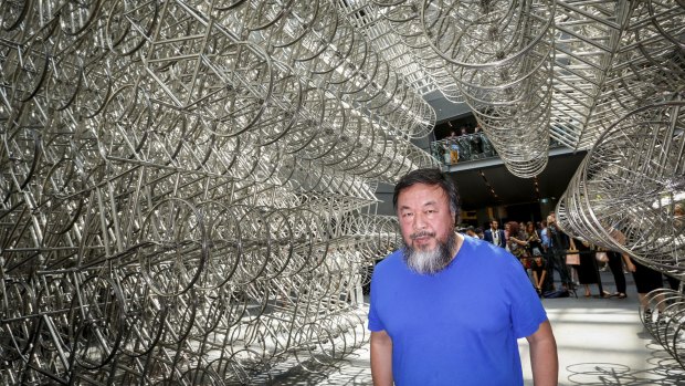 Ai Wei Wei under his bicycle sculpture at the NGV.