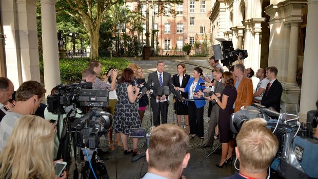 The media gather around the new LNP leaders outside Parliament.