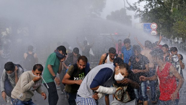 Hungarian police spray water on migrants at the 'Horgos 2' border crossing near Horgos, Serbia.
