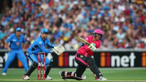 Headed for the boundary: Nic Maddinson of the Sydney Sixers hoists the ball during the semi-final against the Adelaide Strikers.