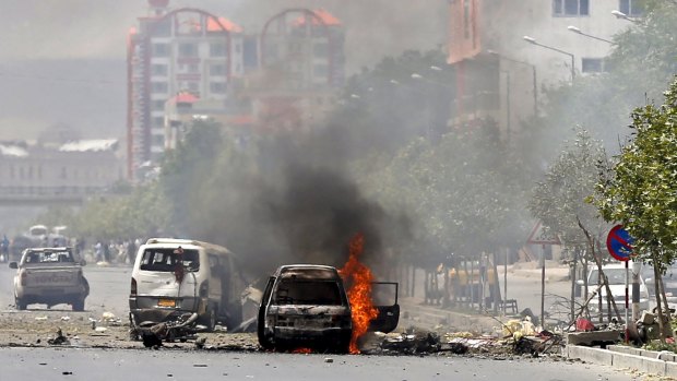A vehicle is seen on fire after a blast near the Afghan parliament in Kabul, Afghanistan on Monday.
