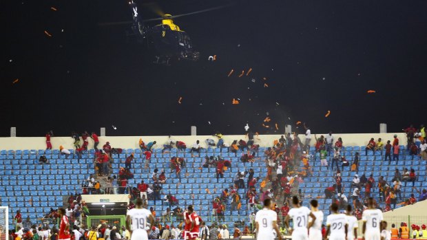 A helicopter hovered overhead as harassed officials dithered over whether or not to abandon the game.