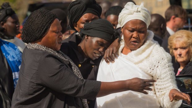 Akon Guode (centre), pictured as she left a funeral service for her children in April, 2015.