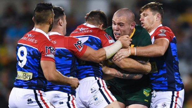 Bulwark: Kangaroos forward David Klemmer is stopped by several French players.