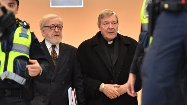 Cardinal Pell, with his lawyer Robert Richter, QC (left), arrives at Melbourne Magistrates Court.