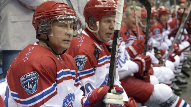 Russian President Vladimir Putin, left, and retired ice hockey player turned member of the Federation Council Vyacheslav Fetisov take part in a gala match of the National Amateur Ice Hockey Teams' Festival.