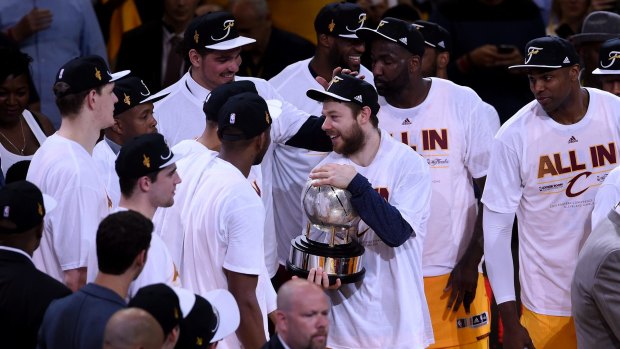Matthew Dellavedova holds the trophy after the Cavaliers defeated the Hawks to make it to the NBA finals.