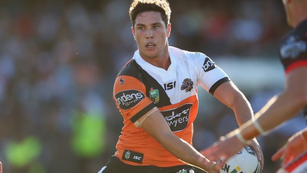 Class act: Mitchell Moses gets the ball away for the Tigers against the Warriors.