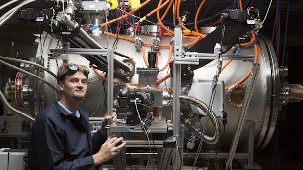 Program leader Tom McGuire stands next to the compact fusion reactor experiment inside his lab at the Skunk Works in Palmdale, California.