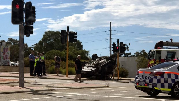 A car flipped onto its roof following a collision in Canning Vale.