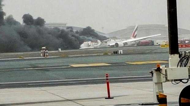 An Emirates plane caught fire after making a crash-landing at Dubai airport.