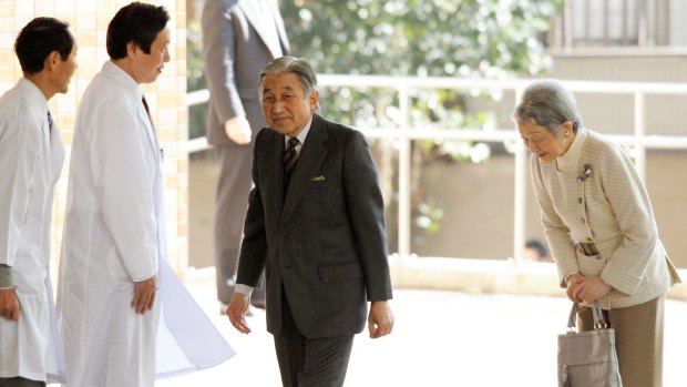 Emperor Akihito arrives at a hospital for treatment in 2012, accompanied by Empress Michiko.