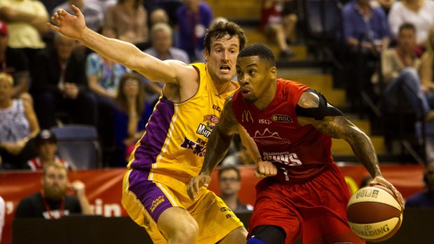 On the attack: Wollongong's Gary Ervin tries to evade Kings guard Ben Madgen.