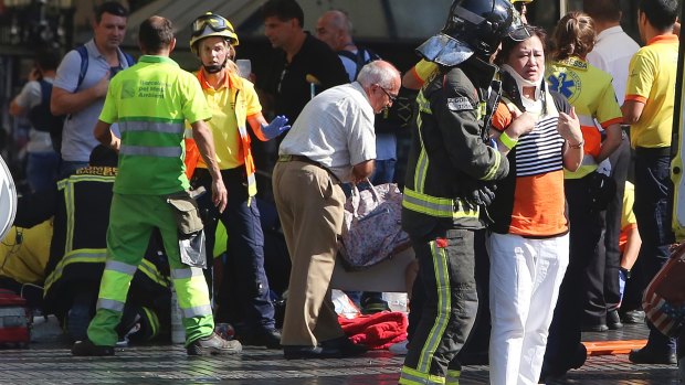 Injured people are treated in Barcelona, Spain, after the vehicle attack.