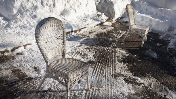 Chicago residents use chairs to reserve a cleared parking spot on their street.