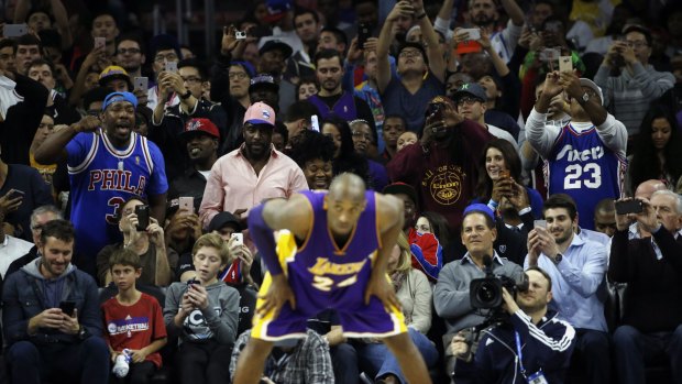 Fans look on at Kobe Bryant.