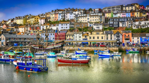 Colourful clifftop houses overlook the waterfront at Brixham, the Riviera's bustling, characterful fishing port.