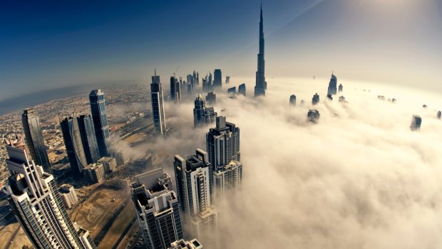 Dubai’s skyscrapers pierce low cloud.