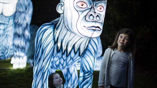 Ophelia Dougall (left) and Laila Callahan with the gorilla light works at Taronga Zoo as part of Vivid Sydney.