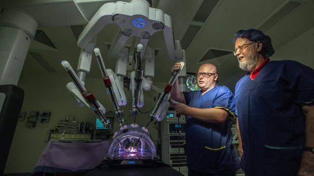Dr Hodo Haxhimolla (no hat) has performed surgery using the da Vinci Xi Surgical System. His first patient was Jim Alexander of Kambah who had a radical prostatectomy with the help of the  da Vinci Xi robot, the first of its kind in the ACT.