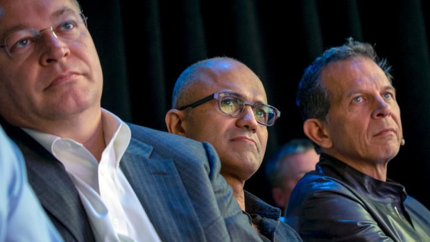 Microsoft's chief executive Satya Nadella (centre) has apologised for suggesting women in tech should trust the system and rely on "karma" to get what they deserve.