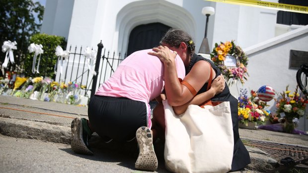  Women comfort each other as they mourn in front of the Emanuel African Methodist Episcopal Church after a mass shooting at the church that killed nine people in Charleston, South Carolina.