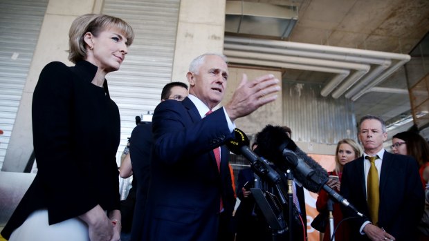 Prime Minister Malcolm Turnbull visits a building site in Belconnen, Canberra, with Employment minister Senator Michaelia Cash.