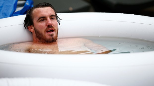 Taking a break: Wallabies forward Kane Douglas sits in an ice bath during an Australia team recovery session at The Lensbury Hotel.