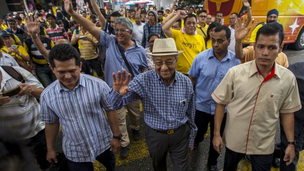 People power: Former Malaysian Prime Minister Mahathir Mohamad joins Sunday's rally in Kuala Lumpur.