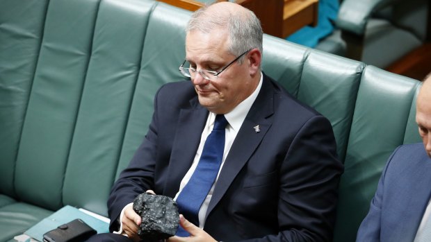 Treasurer Scott Morrison with a lump of coal during question time at Parliament House last year. 