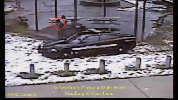 A still image taken from a surveillance video recorded on November 22, 2014, that was played at a news conference held by Cleveland Police shows Cleveland police officers arriving at Cudell Park on a report of a man with a gun. 