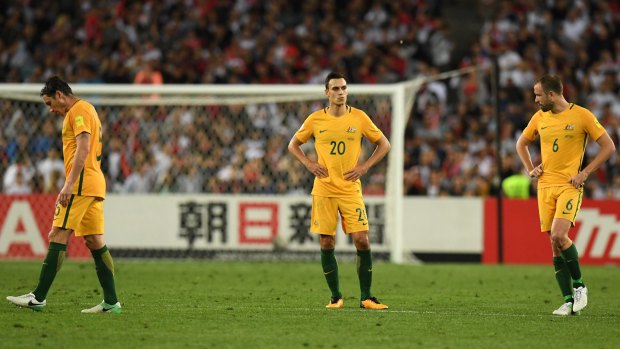 A dejected Mark Milligan, Trent Sainsbury and Matthew Jurman (right) against as the Socceroos struggled against Syria.