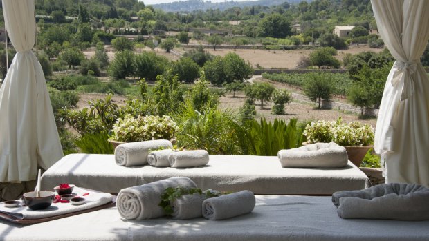 The heated infinity pool is surrounded by daybeds and the sunny terrace has views across an ancient olive grove.