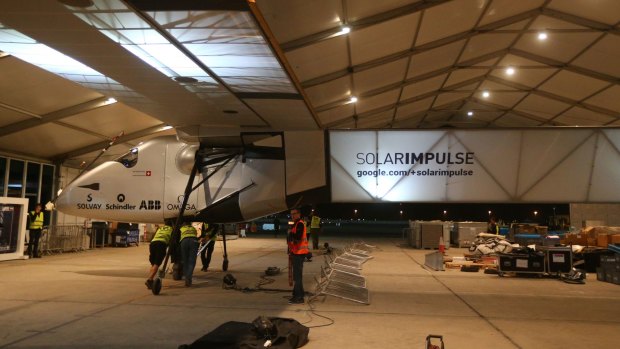 Members of the Solar Impluse 2 team prepare the solar-powered plane before a test flight at Abu Dhabi's small Al-Bateen airport. Organisers hope that Solar Impulse 2 may head off around the globe as early as March 7.