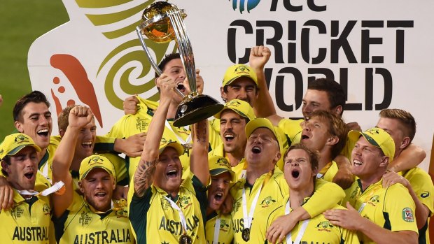 Australian captain Michael Clarke holds aloft the trophy with his teammates as they celebrate their seven wicket win over New Zealand in the World Cup final.
