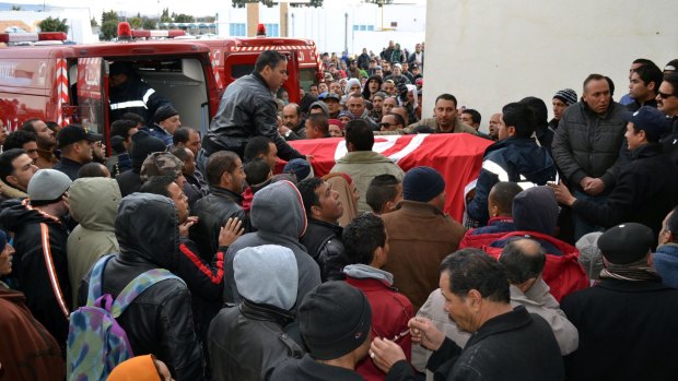 Mourners carry the coffin of one of the Tunisian policemen.