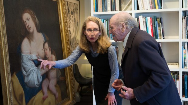 Christina Neilson and Charles Bennett Taylor examine the painting in Sydney on Wednesday.