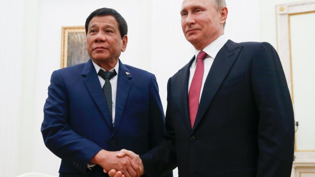 Russian President Vladimir Putin, right, shakes hands with Philippine President Rodrigo Duterte during their meeting at the Kremlin in Moscow on Tuesday.