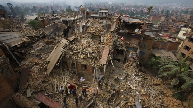 Rescue workers remove debris as they search for victims of earthquake in Bhaktapur near Kathmandu, Nepal.