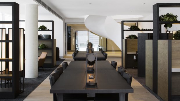 One of the common area, with sculptural, sweeping staircase, in the background, at the Little National Hotel, Canberra.