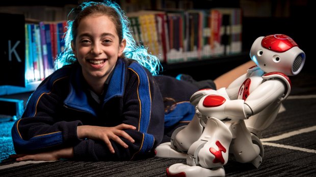 Grade 4 student Romy Szmulewicz with robot Rosie at the Bialik College. 