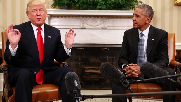 President Barack Obama listens as President-elect Trump speaks to President Obama during their meeting in the Oval Office.